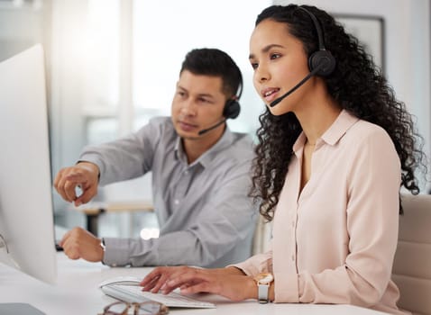 Business people, call center and coaching on computer in customer service, support or telemarketing at office. Businessman training staff or woman in contact us, marketing or telesales at workplace.