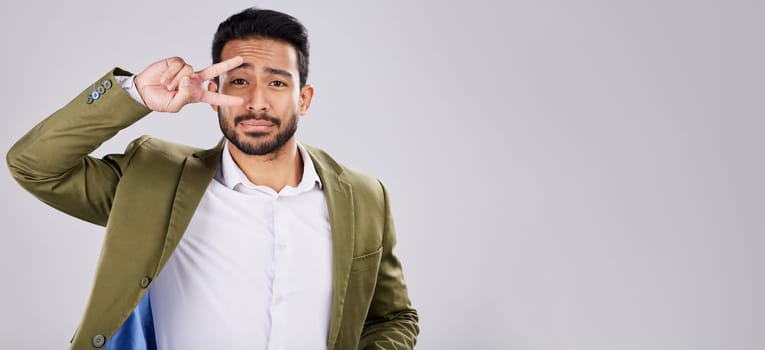 Portrait, peace and mockup with a business man in studio on a gray background for branding or advertising. Marketing, mock up and hand sign with a male employee indoor to promote product placement.