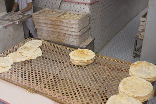 Local bakery of traditional Turkish bread. Fresh flatbread that is baked on a baking sheet or baking sheet. Baked in a pan.