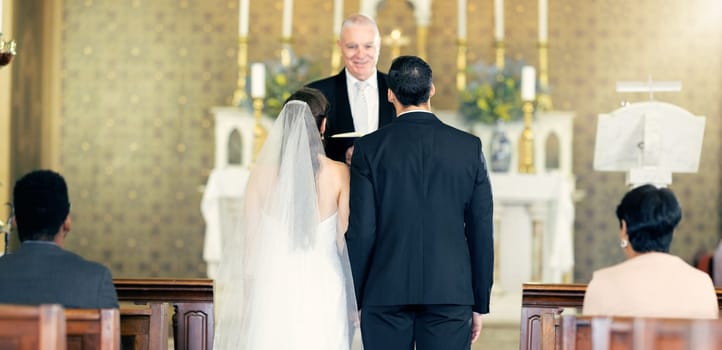 Couple, wedding and priest with commitment, love and marriage ceremony in church service together. Man, woman and pastor with trust, celebration and christian marry event in a chapel or spiritual.