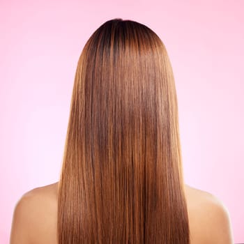 Beauty, hair and back of woman in studio for shampoo, keratin and salon treatment. Health, shine and self care with girl model and growth for glow, textures or cosmetology isolated on pink background.