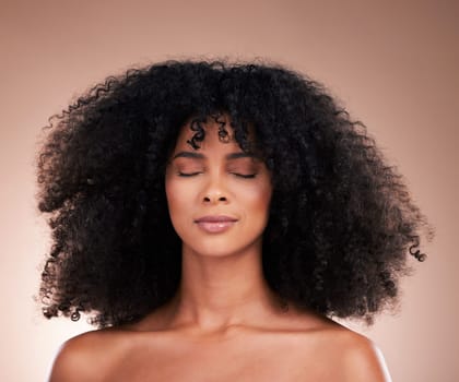 Natural hair, black woman with afro and face, haircare and skincare for beauty on studio background. Female, cosmetic treatment and curly hairstyle, calm and content with texture and facial skin glow.