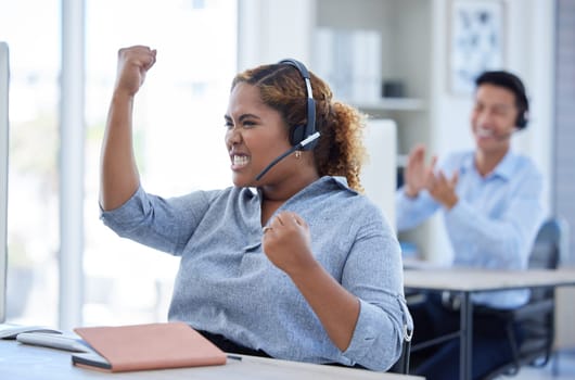 Woman, call center and fist celebration for success at desk for telemarketing or sales target. Excited consultant person winning crm bonus, deal or award with a headset for customer service startup.