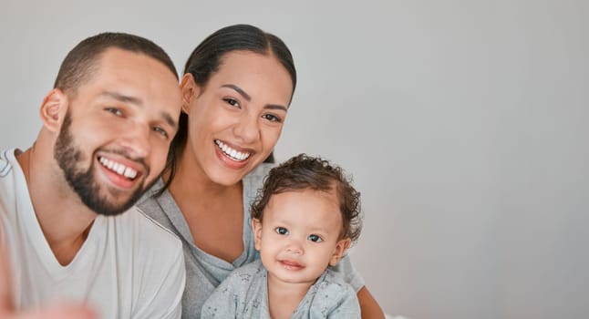 Family, love and happiness portrait with baby for support, care and qaulity time together in studio. Happy, smile and parents with child for relationship bonding or memory picture in grey background.