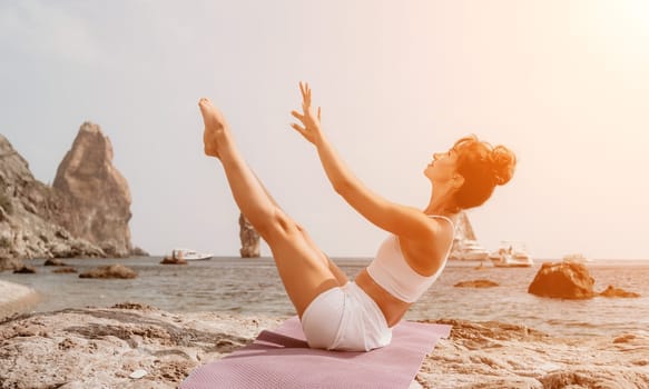 Fitness woman sea. Outdoor workout on yoga mat in park near to ocean beach. Female fitness pilates yoga routine concept. Healthy lifestyle. Happy fit woman exercising with rubber band in park.