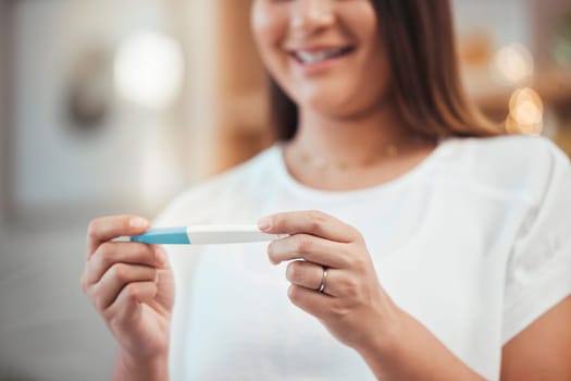 Woman, hand and pregnancy test result with a happy mother to be ready for her baby at home. Mom, pregnant stick test and excited female ready for children or babies feeling happiness about family.