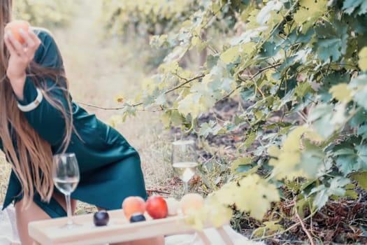 Picnic and wine tasting at sunset in the hills of Italy, Tuscany. Vineyards and open nature in the summer. Romantic dinner, fruit and wine.