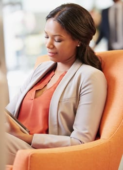 Black woman, tablet and orange chair to relax on internet for banking, communication and social media with wifi for investment or startup business loan. Female entrepreneur using mobile app for work.