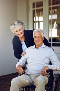 Wheelchair, happy and portrait of senior couple enjoy weekend, quality time and bonding on patio. Retirement home, disability and elderly man and woman smile for relaxing, marriage trust and love.