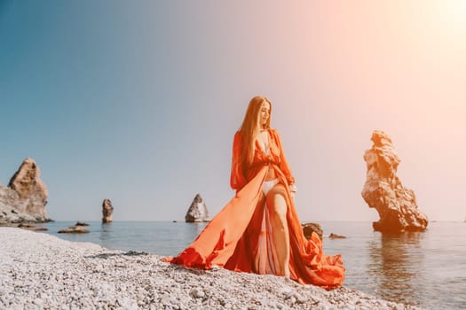 Woman travel sea. Happy tourist taking picture outdoors for memories. Woman traveler looks at the edge of the cliff on the sea bay of mountains, sharing travel adventure journey.