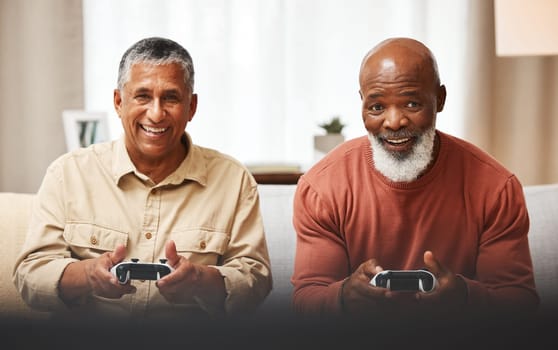 Gamer, fun and senior black man friends playing a video game together in the living room of a home. Sofa, funny or retirement with a mature male and friend gaming or bonding during a visit in a house.