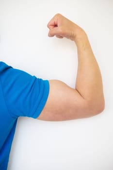 Close up of a handsome male hand showing biceps on a white background. Health and sport concept. Close-up, place for an inscription.