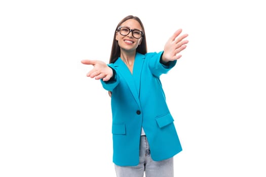 young pretty office worker woman in a blue business jacket looks successful and happy on a white background with copy space.