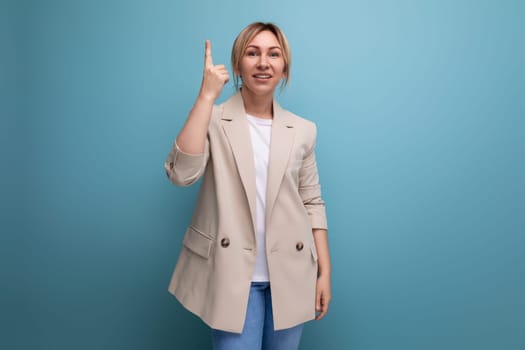 positive confident blonde young adult in jacket showing class on studio background with copy space.