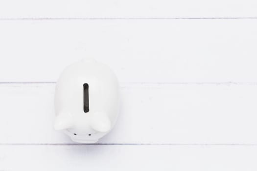 Top view of saving piggy bank on white table background for investment, business, finance and saving money concept