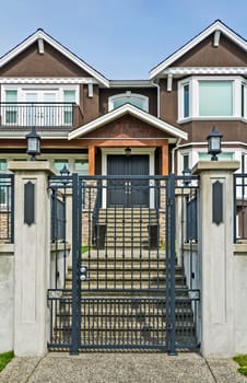 Luxury residential houses with metal gate at the front.
