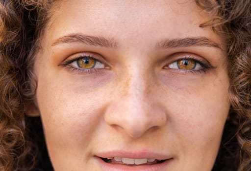 Close-up portrait of happy young woman face smiling friendly open eyes glad expression looking at camera dreaming resting relaxation feel satisfied good news outdoors. Pretty girl in sunny city street