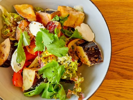 Vegetarian Eggplant Salad with Baked Aubergine, Cherry Tomatoes and Cilantro Close Up.