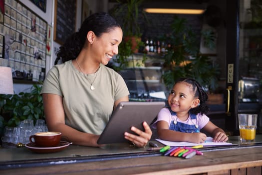 Black family, children and remote work in a coffee shop with a mother and daughter sitting together by a window. Kids, tablet and freelance business with a woman and female child bonding at a cafe.