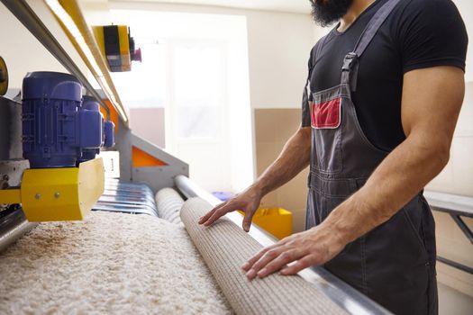 Man operating carpet automatic washing machine in professional cleaning service