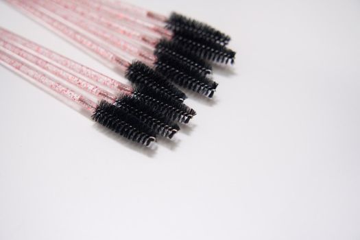 eyelash brushes on a white background with copyspace