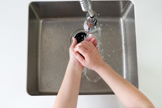 Woman washing hands with antibacterial soap for corona virus prevention, hygiene to stop spreading coronavirus covid19