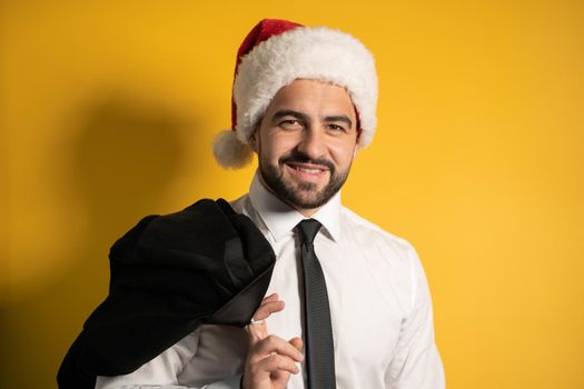 Christmas, business Concept. Man bearded wear formal suit and Santa hat smile on yellow isolate background. High quality photo