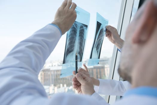 Healthcare, medical: Group of doctors discuss and looking x-ray in a clinic or hospital