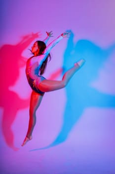 High jump, flight. Flexible girl, rhythmic gymnastics artist jumping. Grace motion action