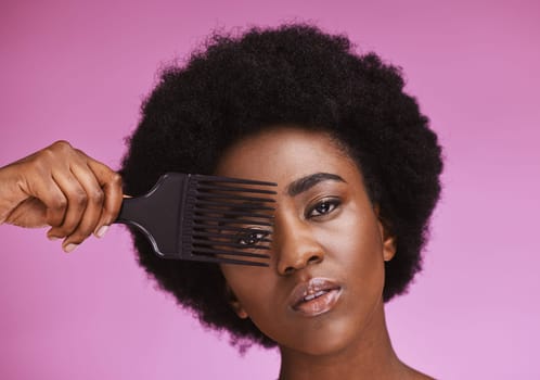 Portrait, hair or afro brush on beauty background in relax grooming routine, texture maintenance or growth wellness. Black woman, face or natural hairstyle comb with skincare makeup on isolated pink.