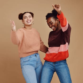 Happy, teenager and girl with dance and friends, young and trendy with gen z style, fun and freedom against studio background. Laughing, funny and dancing with stylish youth, energy and marketing.