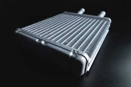 Spare background car radiator of the heating and air conditioning system, car stove radiator, black background close-up, selective focus