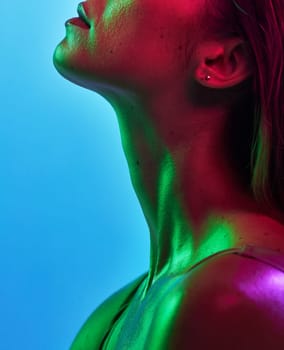 Woman neck, skincare or neon lighting on isolated blue background in trendy, cool or stylish fantasy art in studio. Zoom, beauty or model body glow in creative aesthetic, green or pink lights texture.
