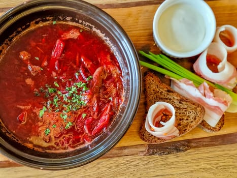Traditional Ukrainian Russian borscht . Bowl of red beet root soup borsch with white cream . Beet Root delicious soup .