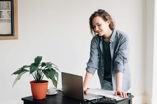 Young Businesswoman Working on Laptop at Office. Student Girl Embracing Productivity in Modern Workspace. Freelance, Business Casual, and Vibrant Lifestyle Concept