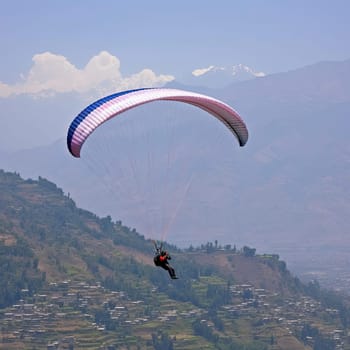 Paraglider flying over the mountains (ID: 001242)