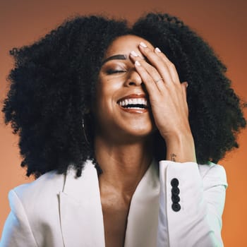 Happy black woman, face and hand with hair and beauty, manicure and hair care with afro against studio background. Funny, pride and cosmetic skincare, facial and natural curly hair texture with laugh.