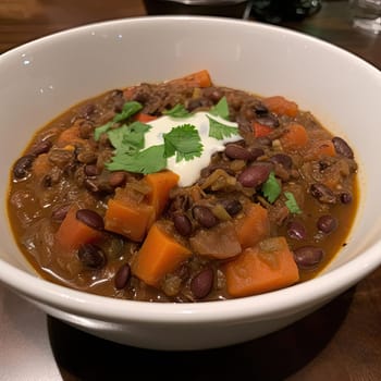 Beef stew with carrots and beans in a bowl with sour cream (ID: 001447)