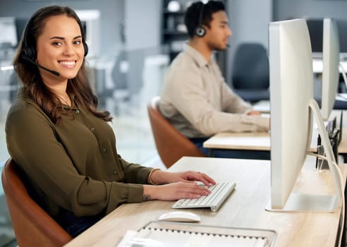 Woman typing at computer, call center and contact us with communication and CRM with tech support. Customer service, help desk and telemarketing, female consultant and smile in portrait with telecom.
