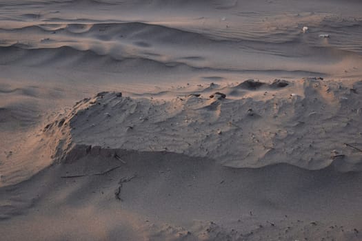 Sand dunes created by the wind. Lay flat.