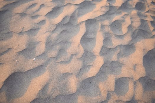 Sand dunes created by the wind. Lay flat.