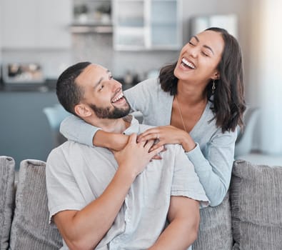 Couple relax on sofa, laugh and smile together with love, support and hug partner in living room of modern apartment home. Black woman, happy man and peace in lounge with wellness bonding on a couch.