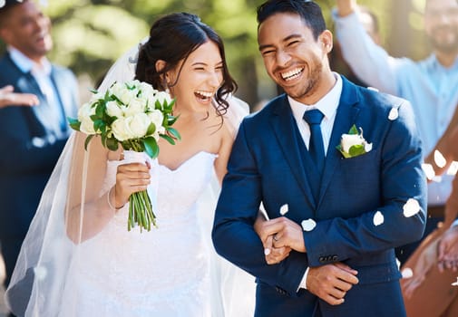 Love, laughing and couple walking at their wedding with guests in celebration of romance. Happy, smile and young bride with bouquet and groom with crowd celebrating at the outdoor marriage ceremony