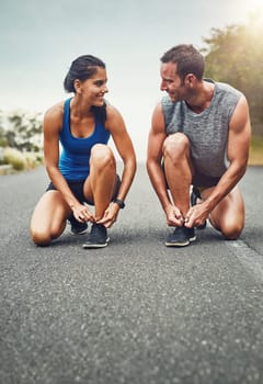Together we will complete this goal. a young attractive couple training for a marathon outdoors