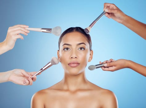 Cosmetic brush, model and portrait for wellness, beauty tools and face treatment. Cosmetics, makeup artist and application brushes for dermatology and woman products in a studio with blue background.