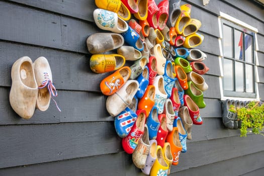 Netherlands. Plank wall of a rural house with a window. Many national Dutch Klomp shoes are nailed with heart-shaped nails