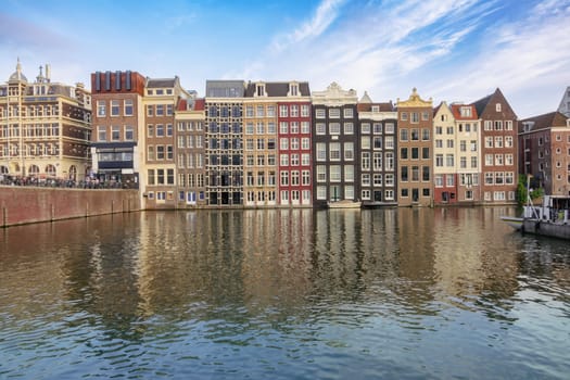 Netherlands. Summer day in Amsterdam. Houses by the water and reflections in the canal