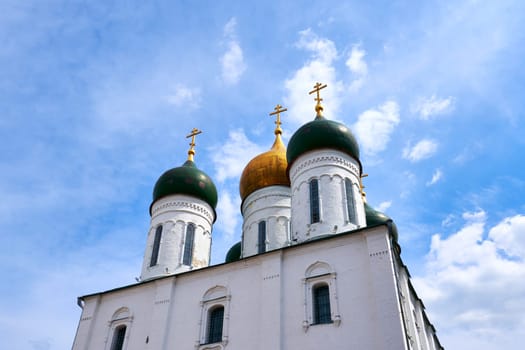 Old Russian Christian Cathedral against the blue sky with white clouds