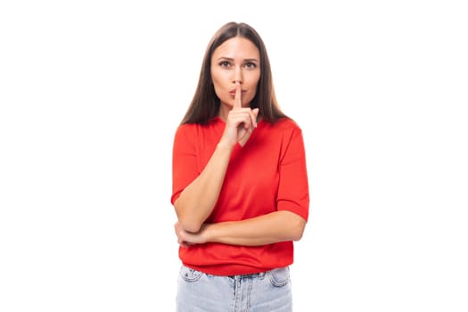 a young European woman with dark straight hair dressed in a red short-sleeved shirt keeps a secret.