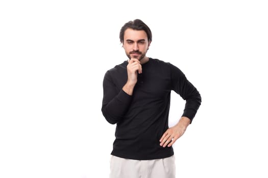 close-up of a young well-groomed brunette man with a haircut and a beard dressed in a black jacket isolated on a white background with copy space.